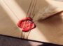 brown envelope with red wax seal